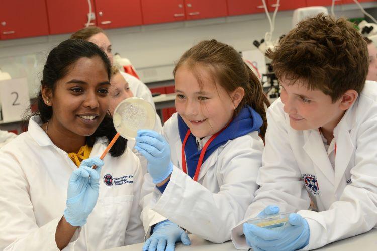 A scientist helping pupils in the lab
